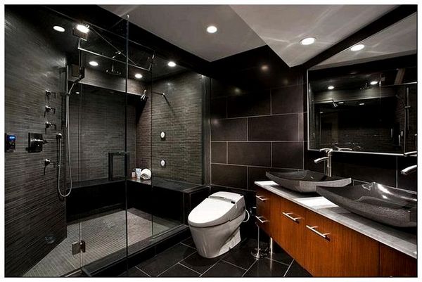 Небольшая ванная комната с черной матовой плиткой.